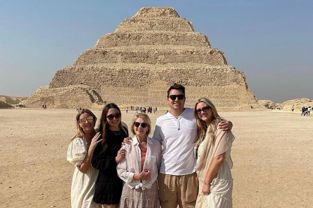 a group of people standing in front of a pyramid