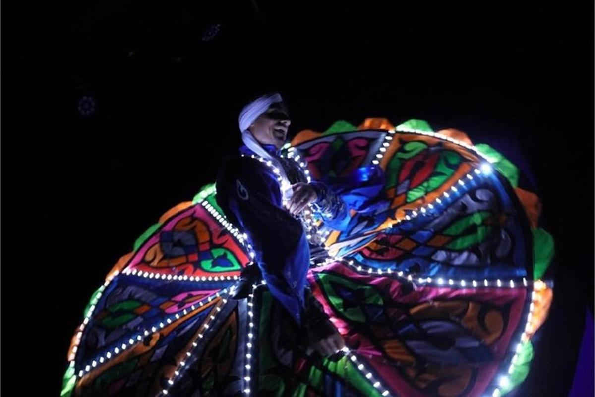 a man riding on top of an elephant with a butterfly