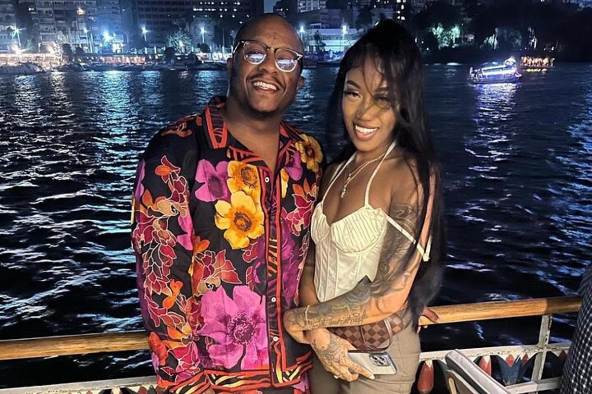 a man and a woman standing on a boat on the water