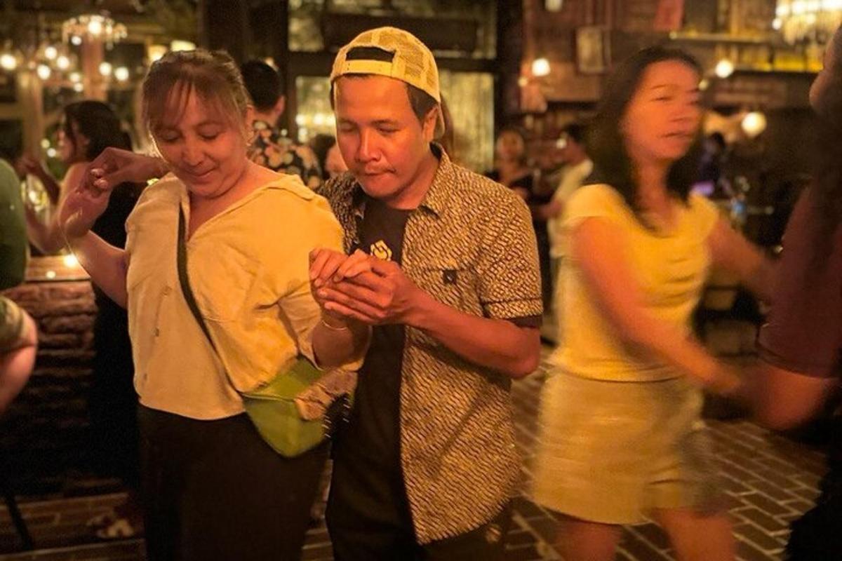 a man and a woman looking at a cell phone