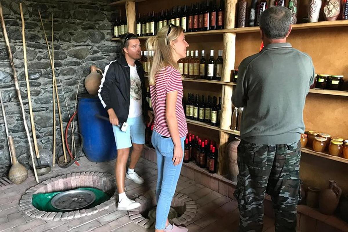 a group of people standing in a wine cellar