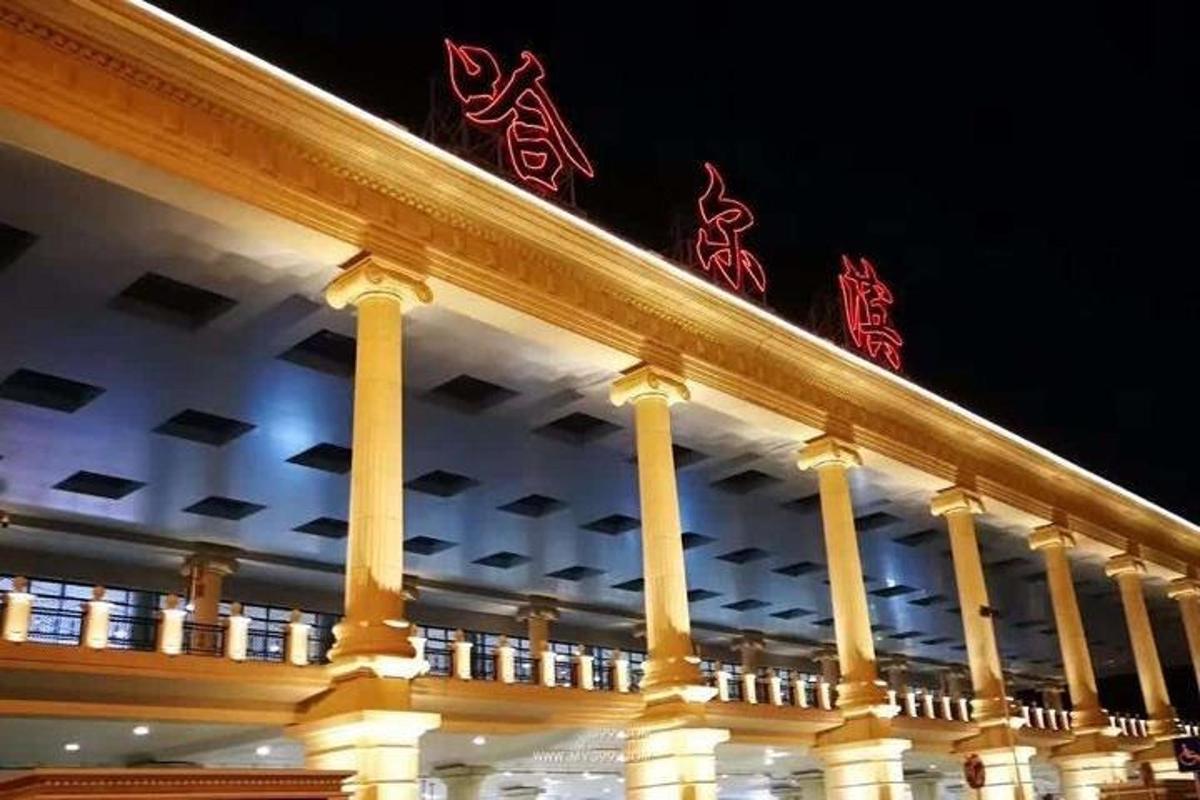a building with red signs on top of it at night