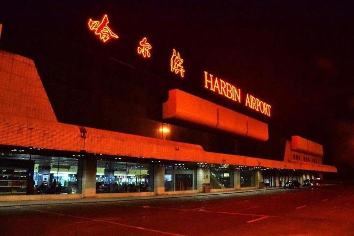 a building with neon signs on top of it at night