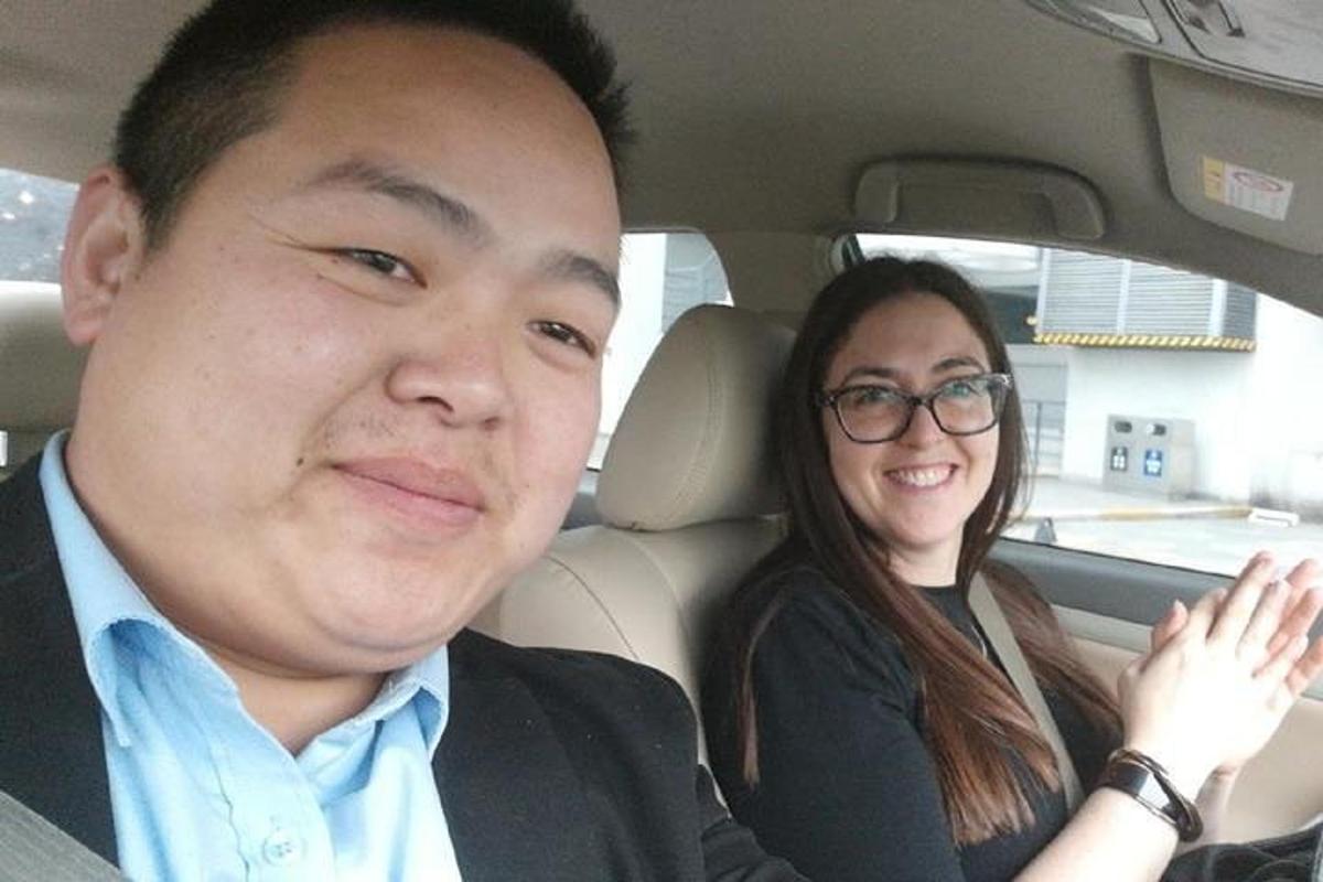 a man and a woman sitting in a car
