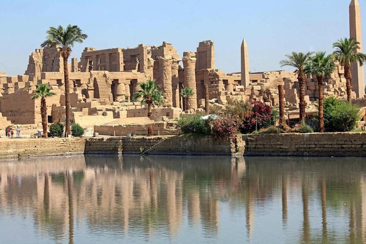 a building with palm trees and a body of water