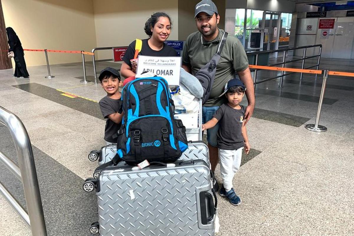a man and a woman and two children with a suitcase