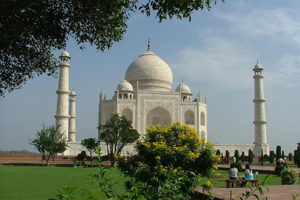 a large white building with three domes in a park