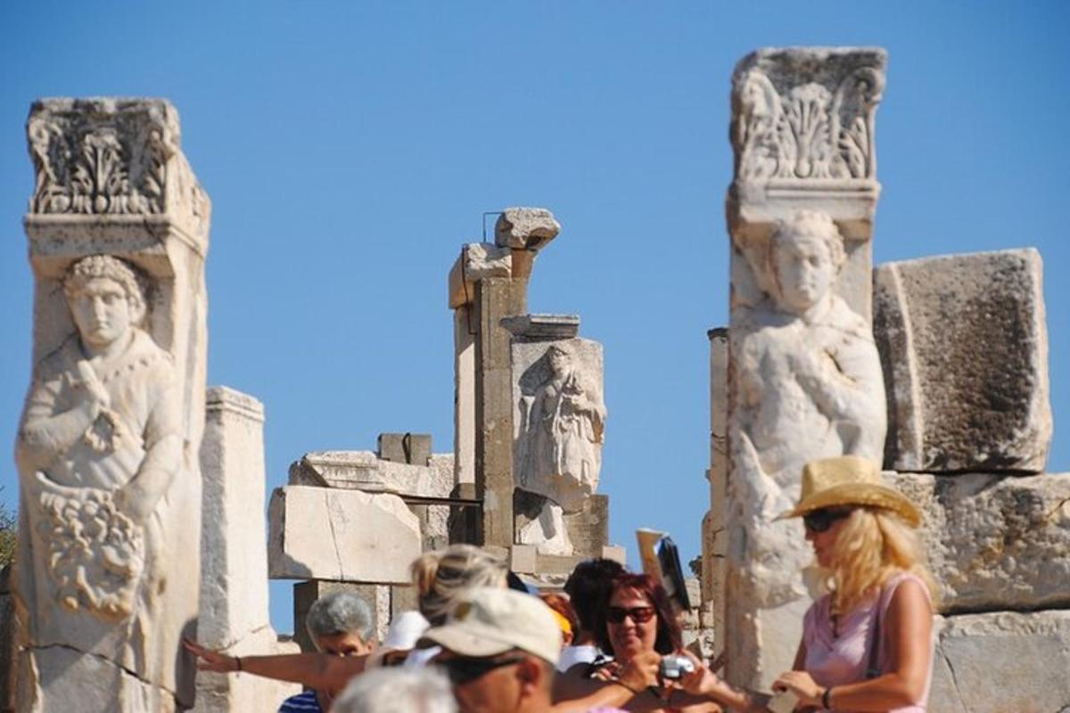 a group of people standing in front of statues