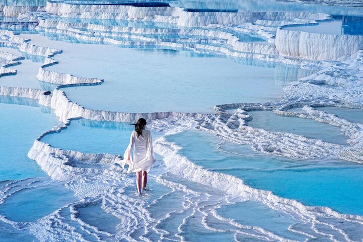 a woman is walking on an ice formation in the water