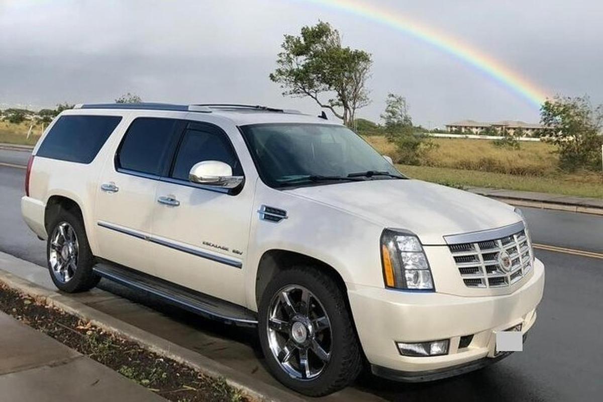 a white truck parked on the side of a road with a rainbow