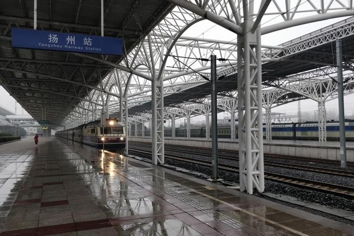 a train station with two trains on the tracks