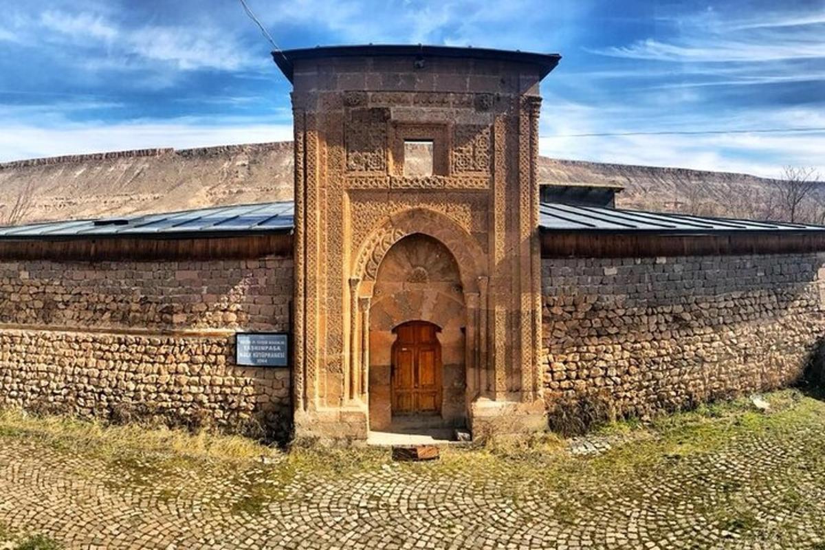 un edificio in mattoni con una porta di legno e un muro di mattoni
