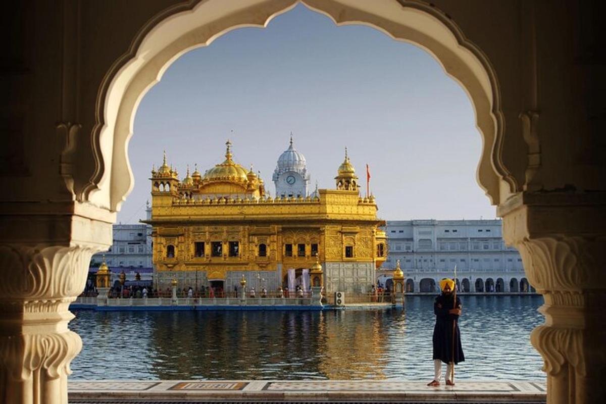a woman standing in front of a golden temple