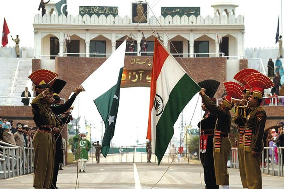 a group of men holding flags in front of a crowd
