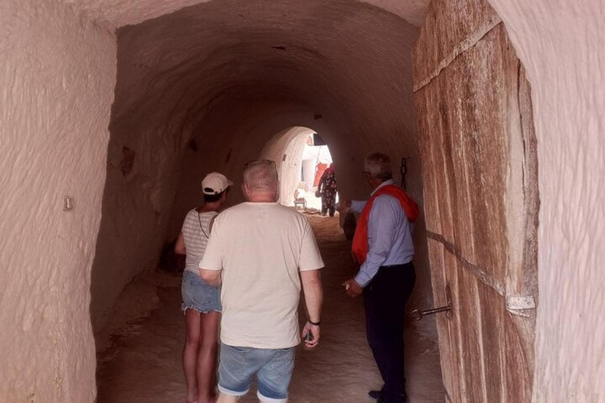 a group of people walking through a tunnel