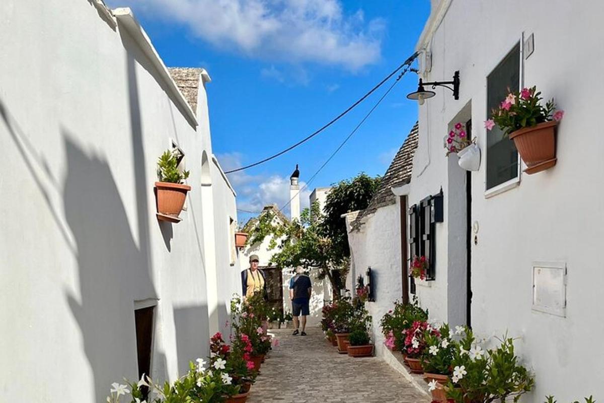 a couple of people walking down a narrow street