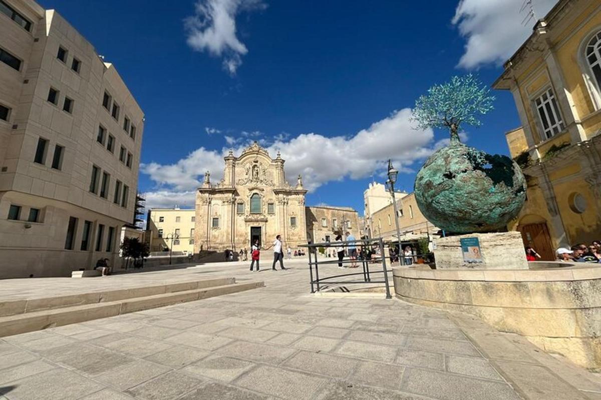 a building with a statue in the middle of a street