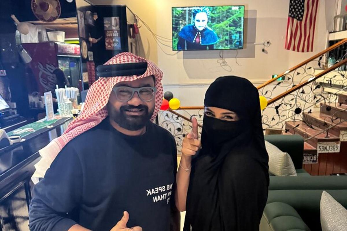 a man and a woman dressed in black posing for a picture