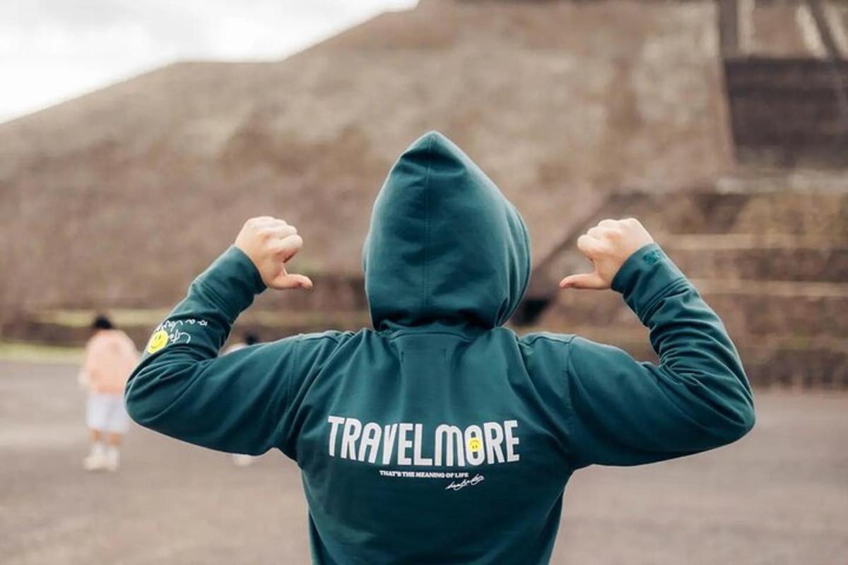 a person in a hoodie with their hands up