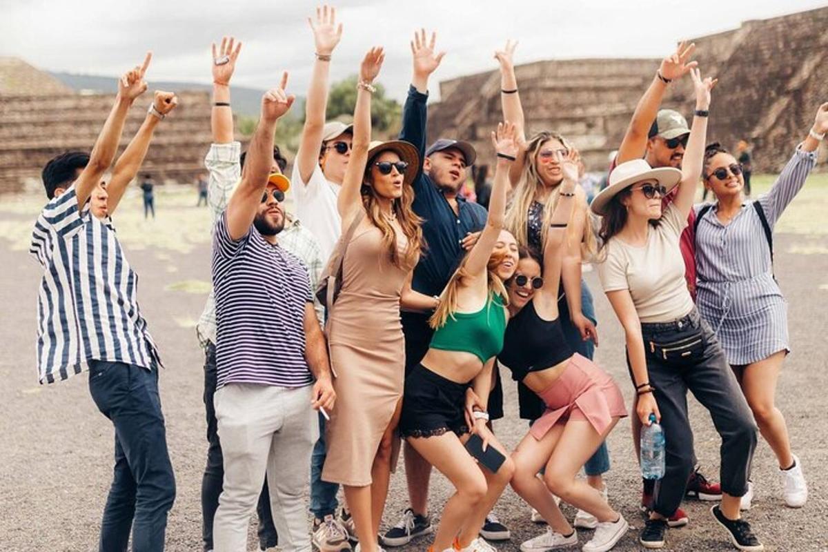 a group of people with their hands in the air