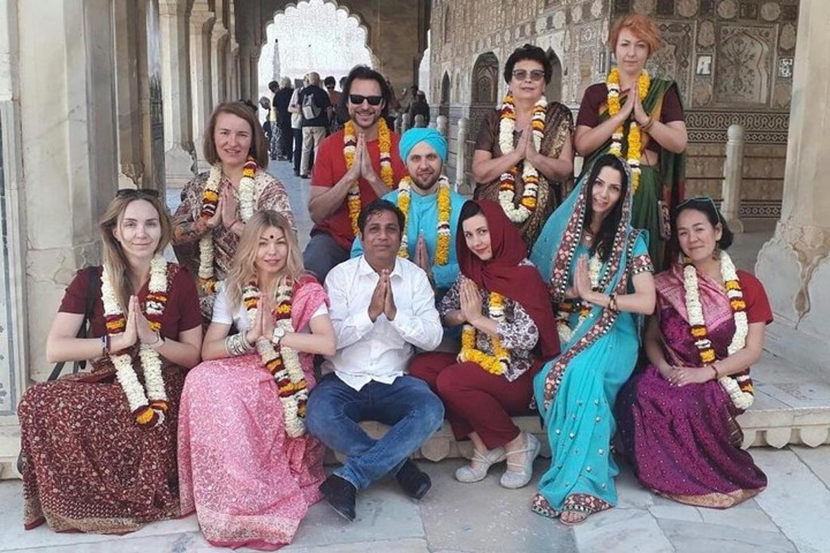 a group of people posing for a picture in front of a building