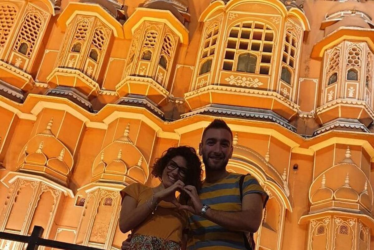 a man and a woman standing in front of a building