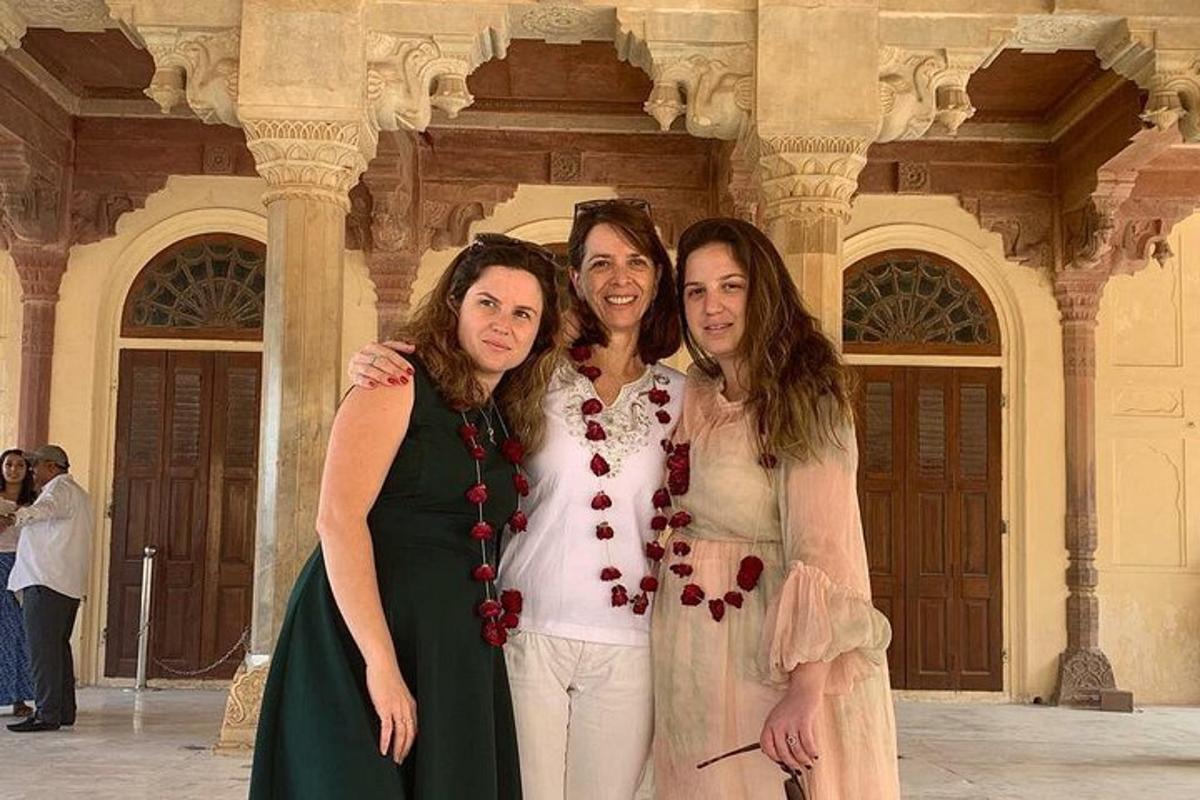three women posing for a picture in front of a building