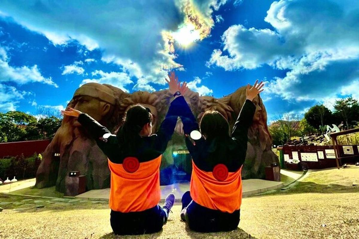 two girls are sitting in front of an amusement park