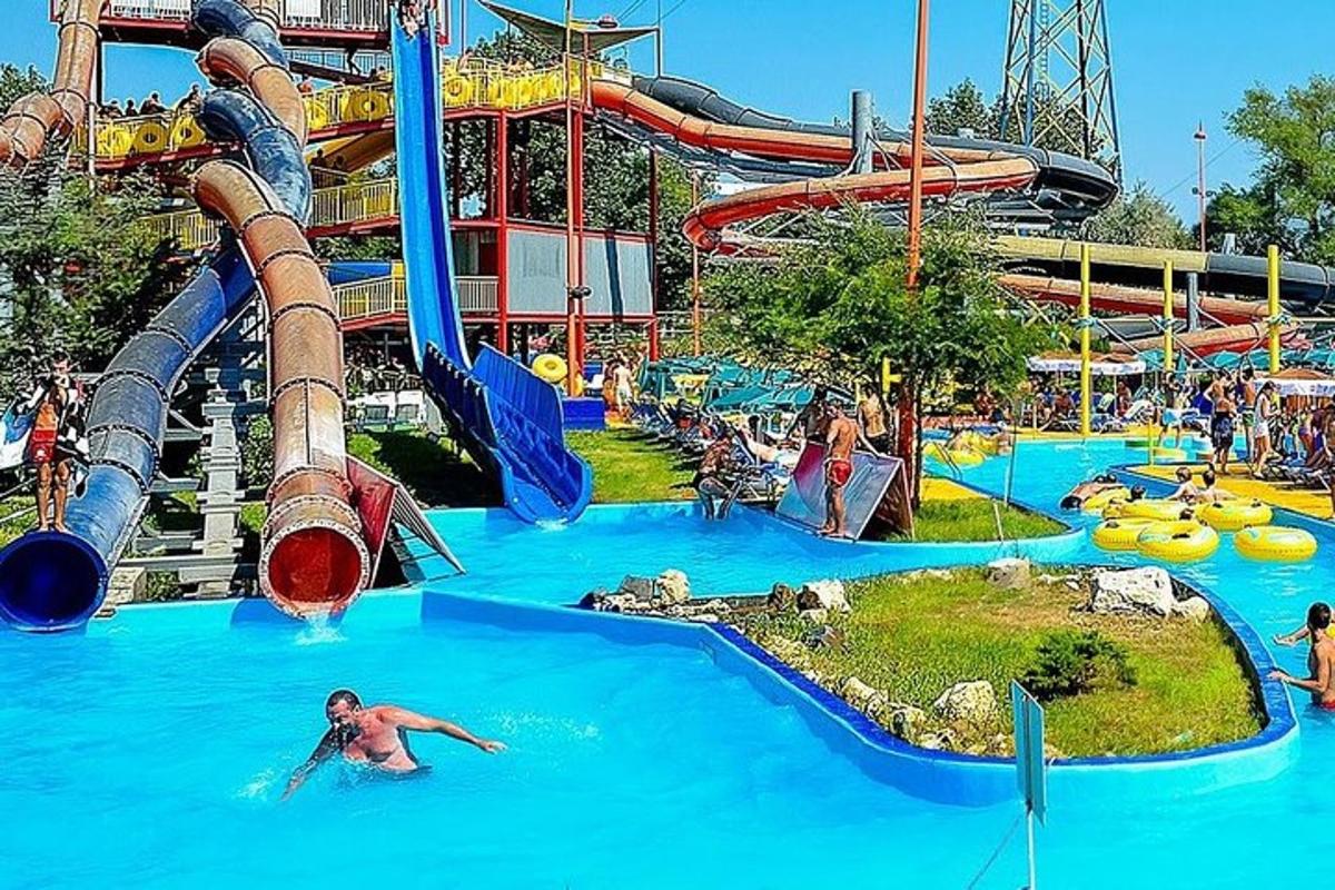 Un parque acuático con un tobogán y gente en él.
