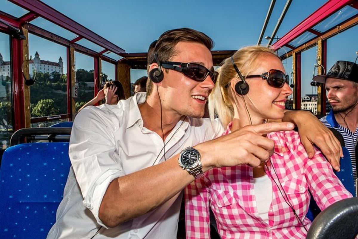 a man and a woman wearing headphones on a bus