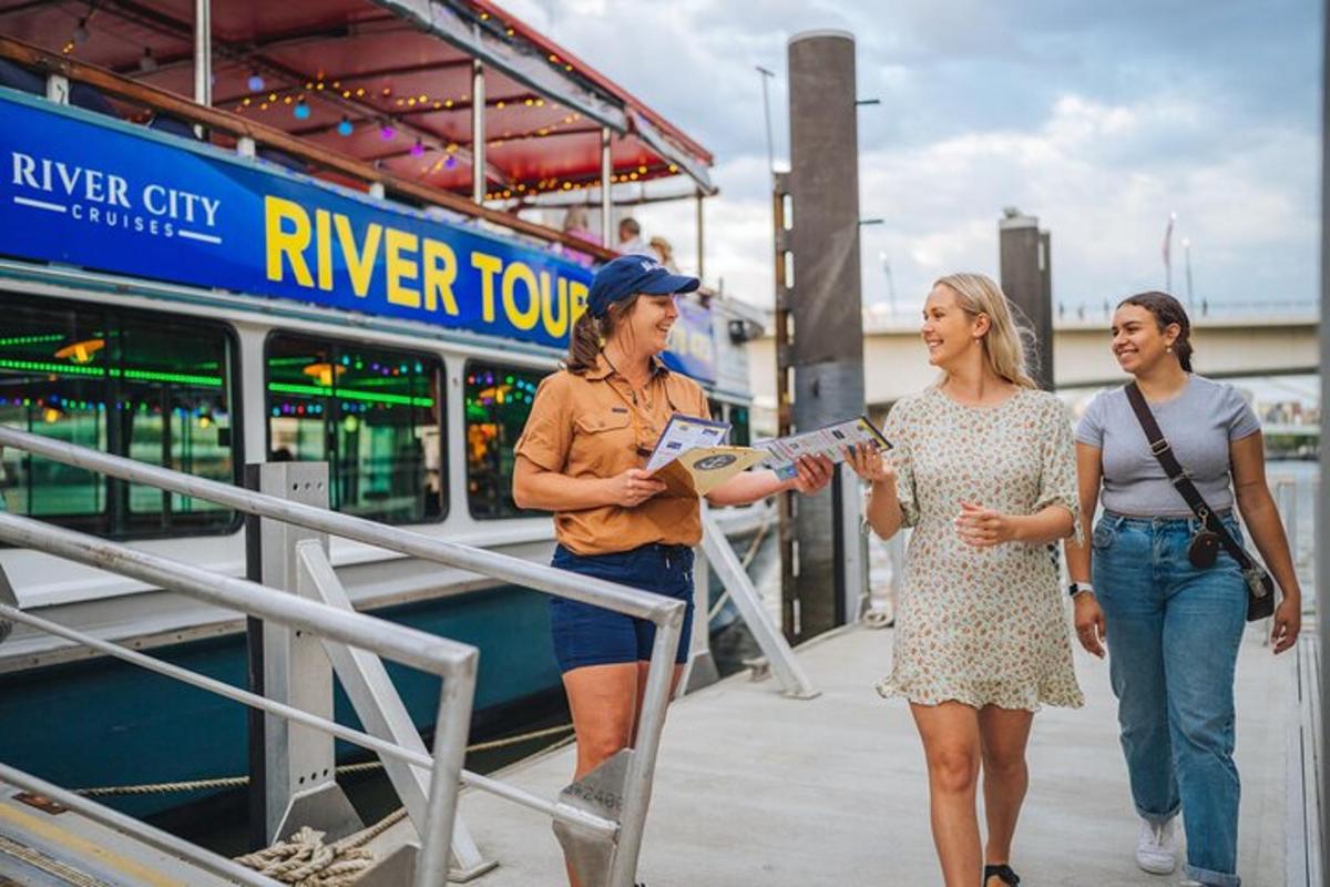 a group of three women standing next to a boat