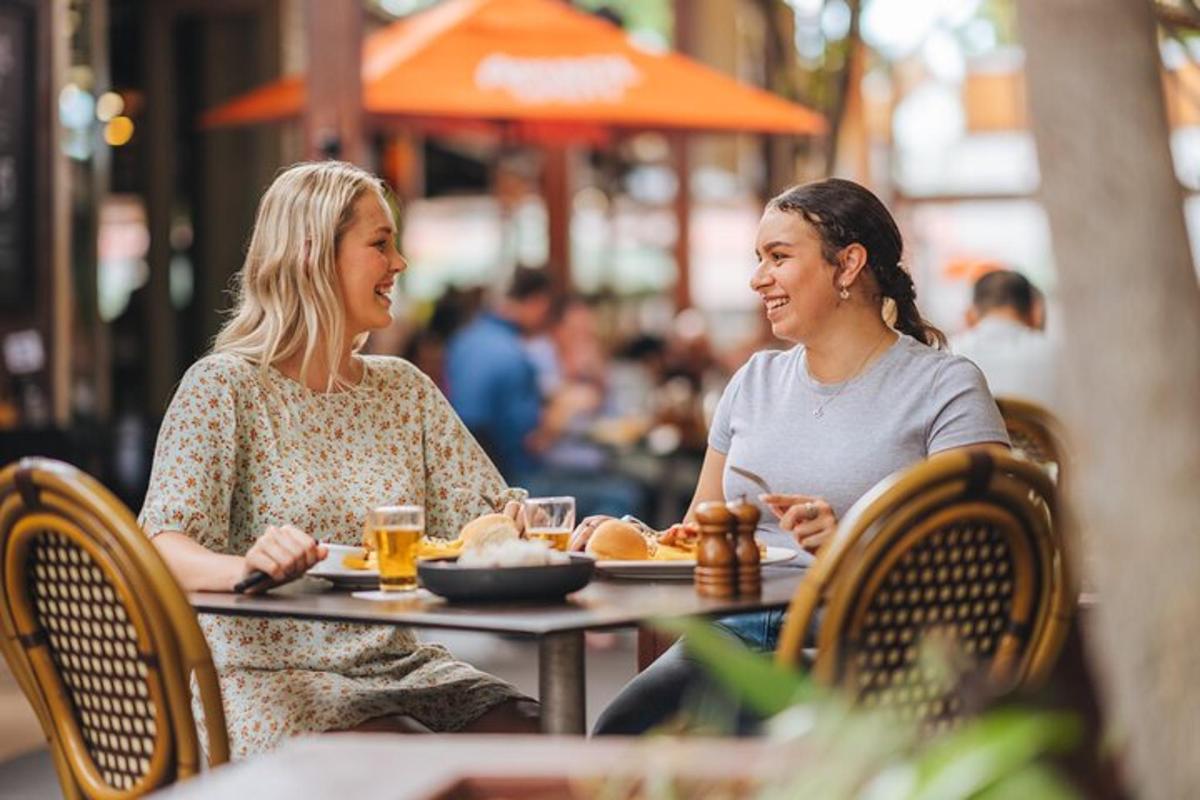 two women sitting at a table in a restaurant