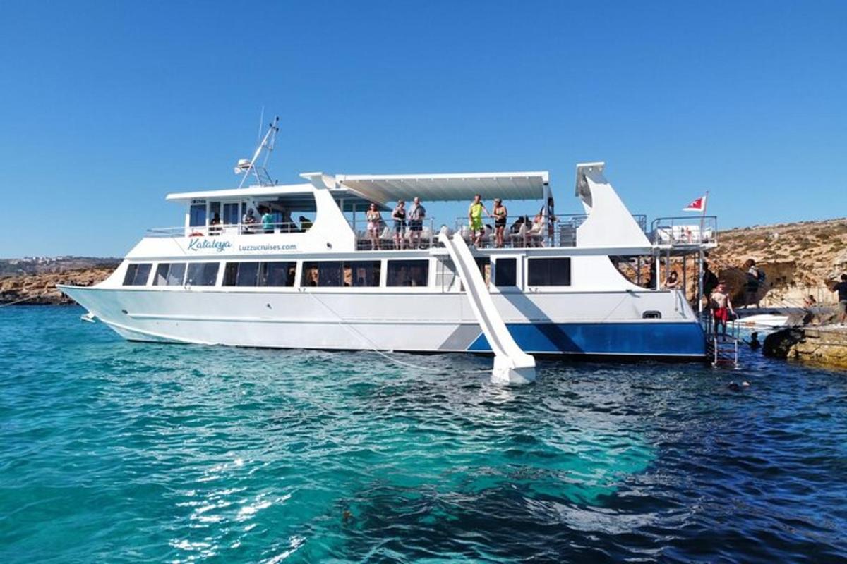 a white boat in the water with people on it