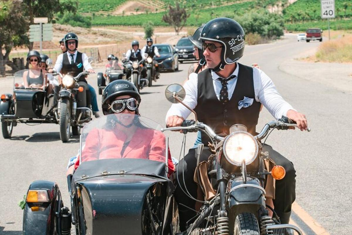 a group of people riding motorcycles with a side car