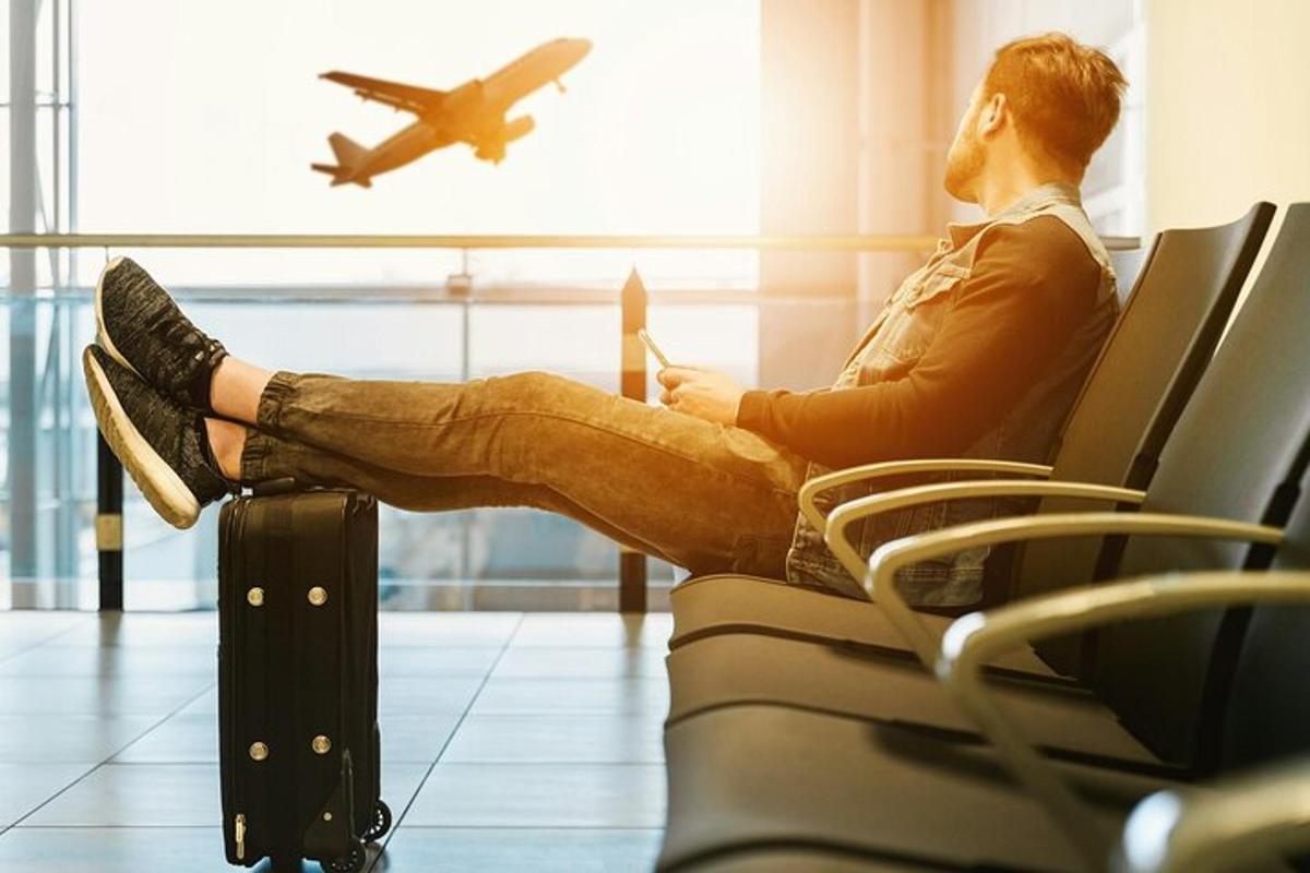 a man sitting in an airport waiting for his plane