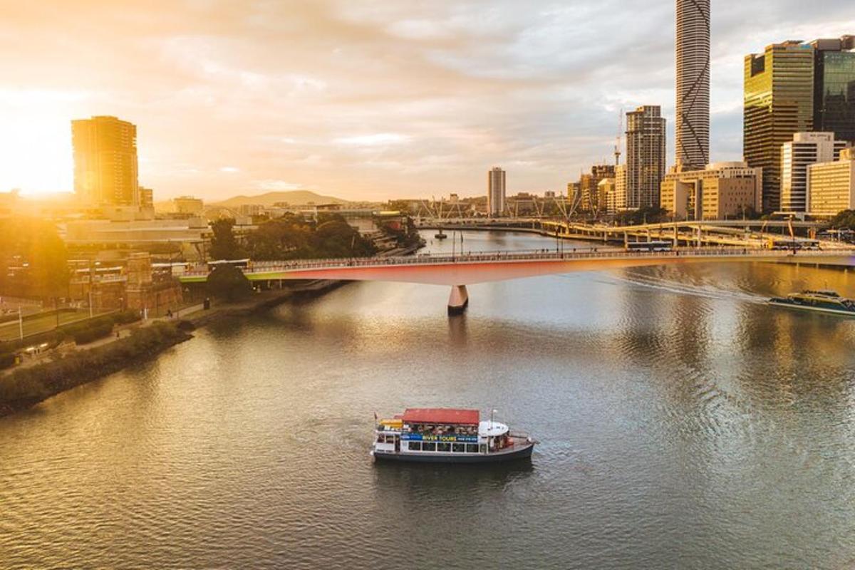 a boat on a river in a city with a bridge