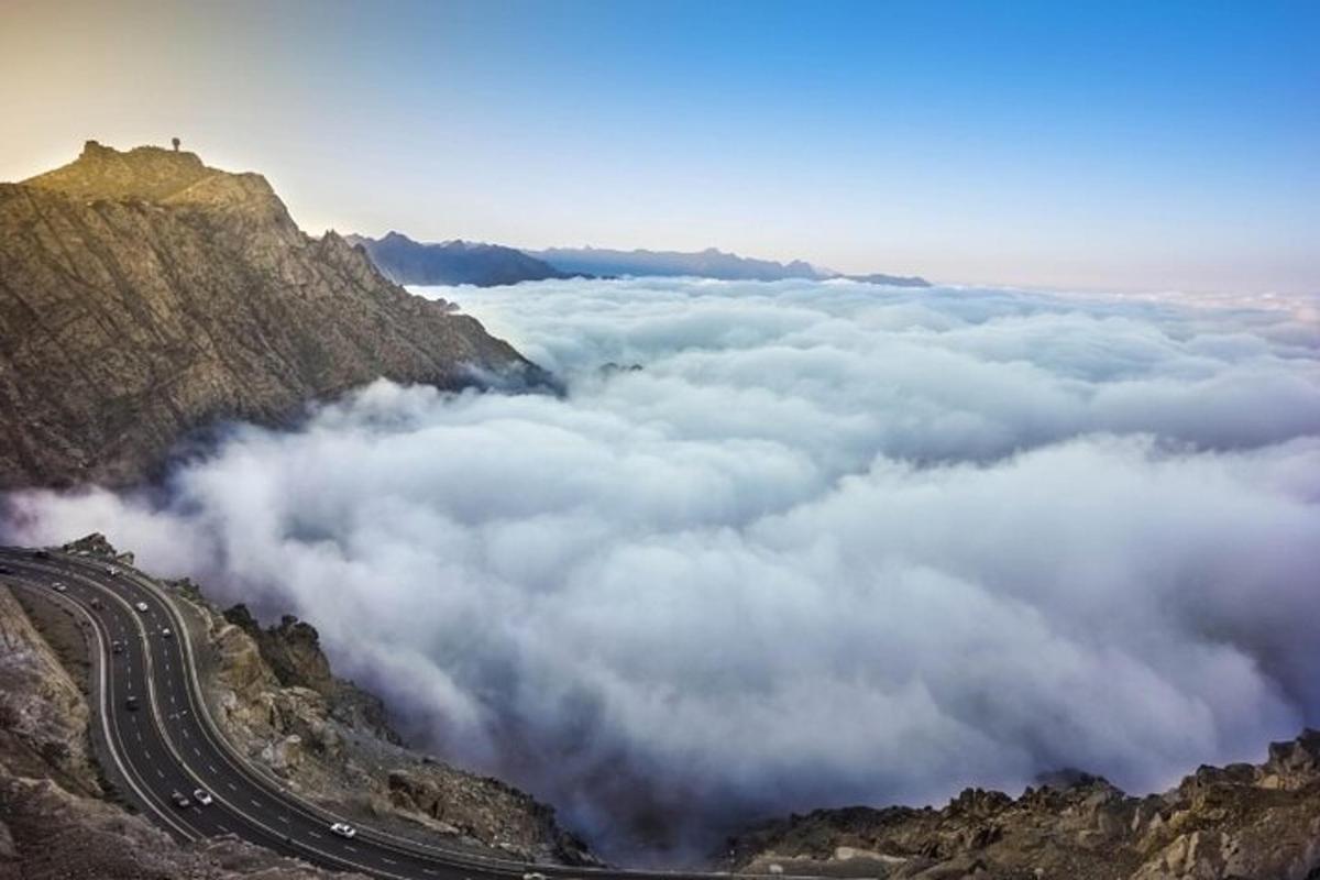 a view of clouds from the top of a mountain