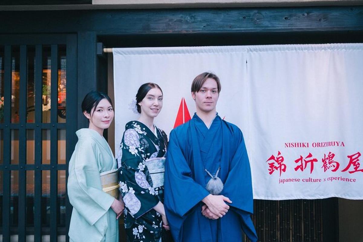 a group of three people standing in front of a banner