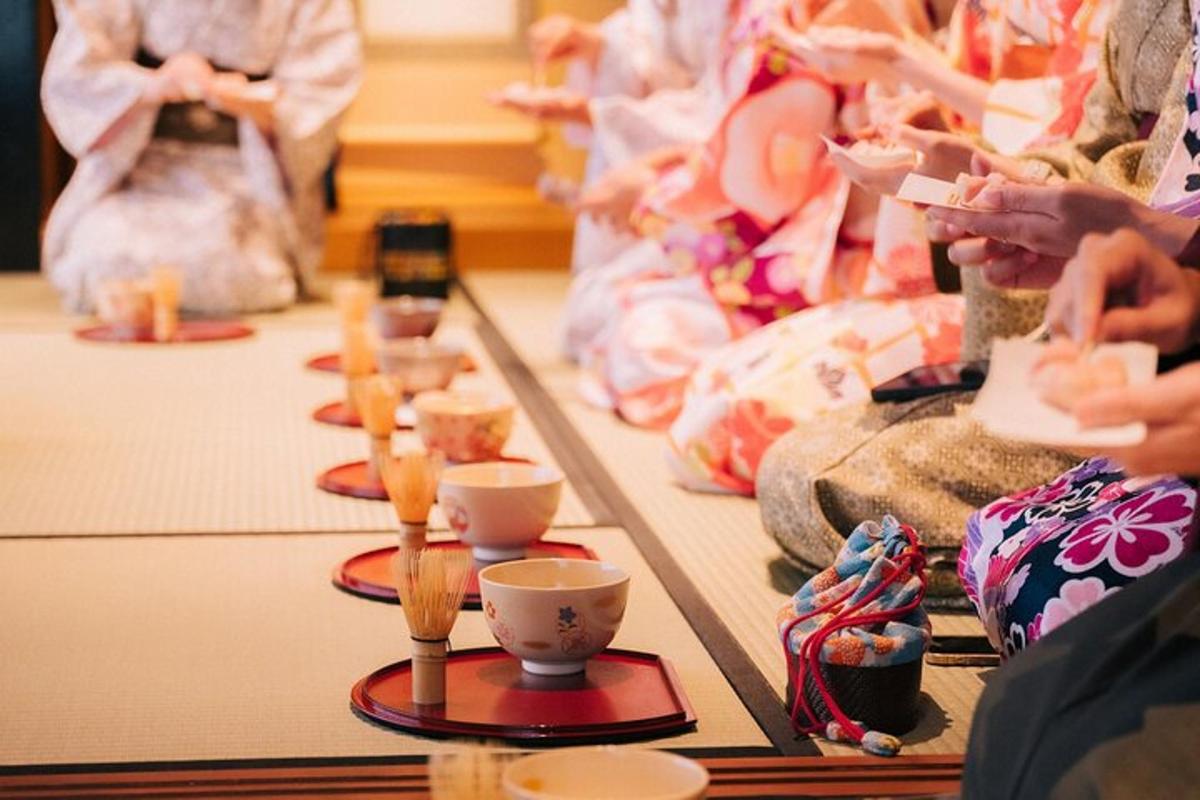 a group of people sitting around a table with cups