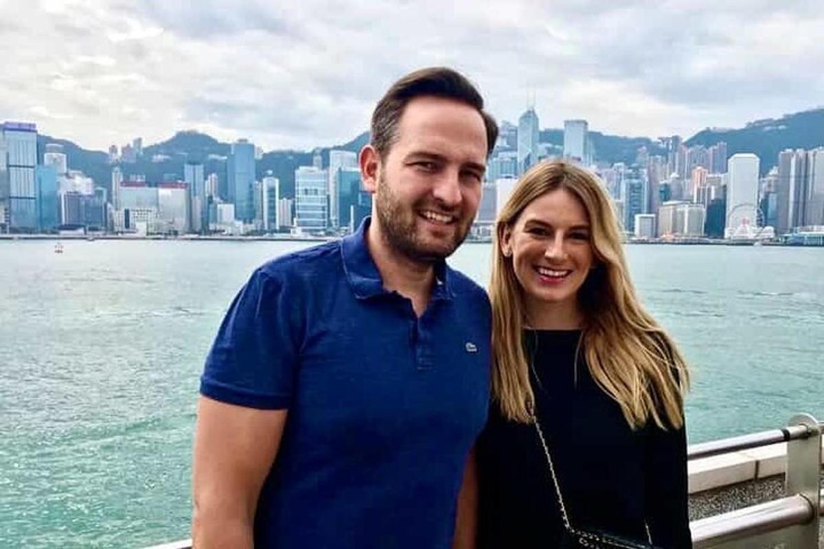 a man and a woman standing in front of a city