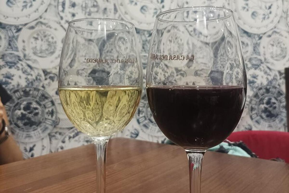two glasses of wine sitting on a wooden table