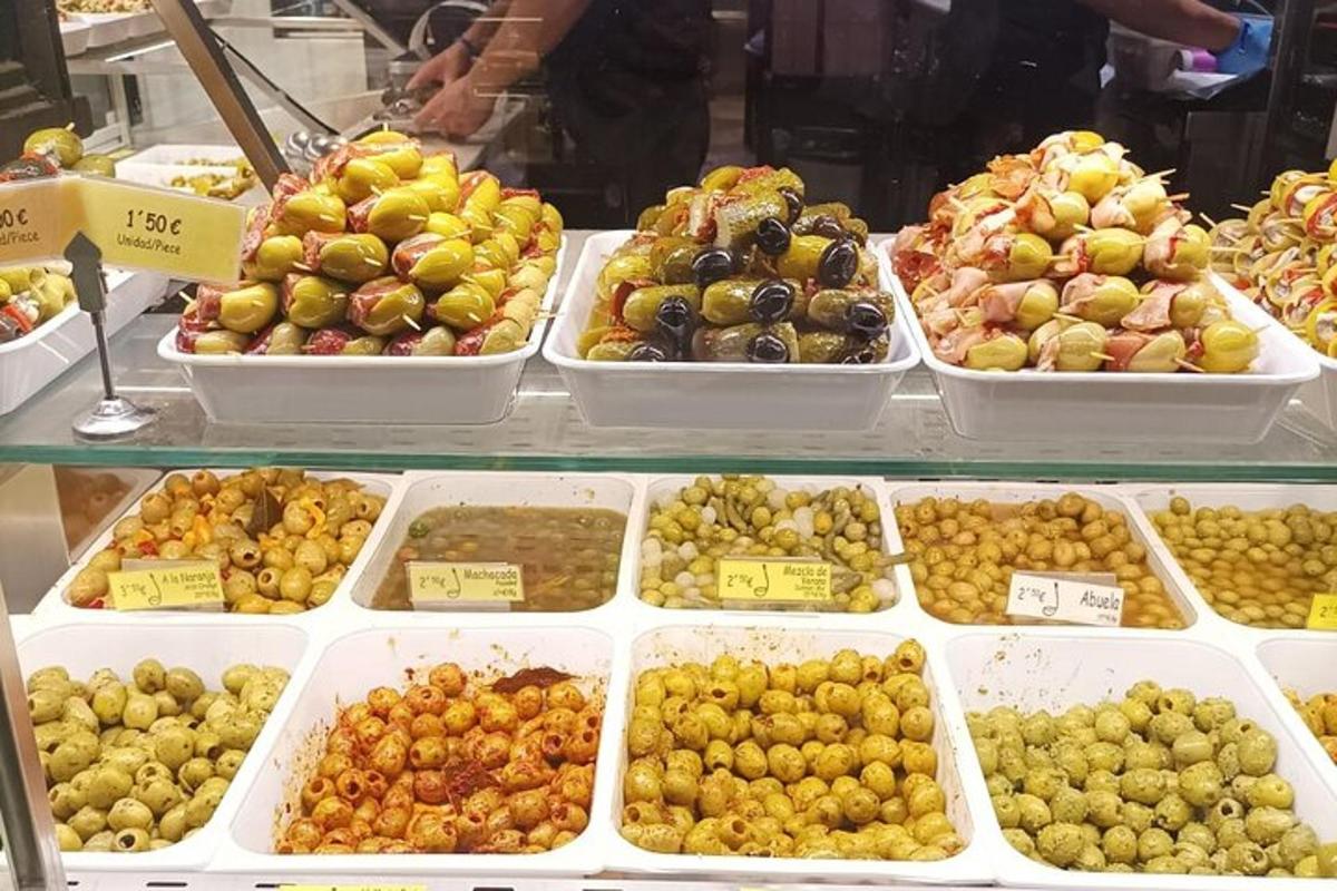 a display case with many different types of olives