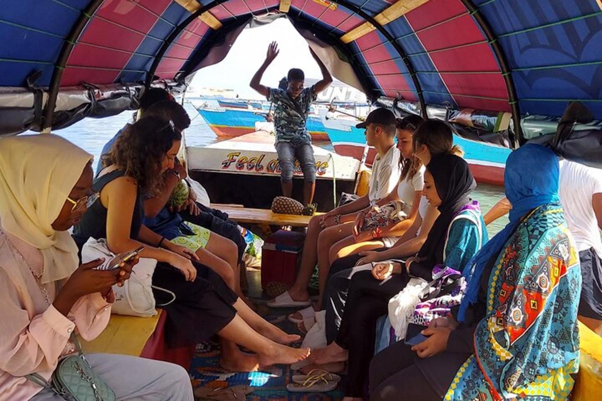 a group of people sitting in the back of a boat