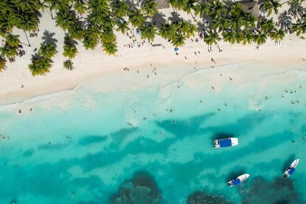 an aerial view of a beach with boats in the water