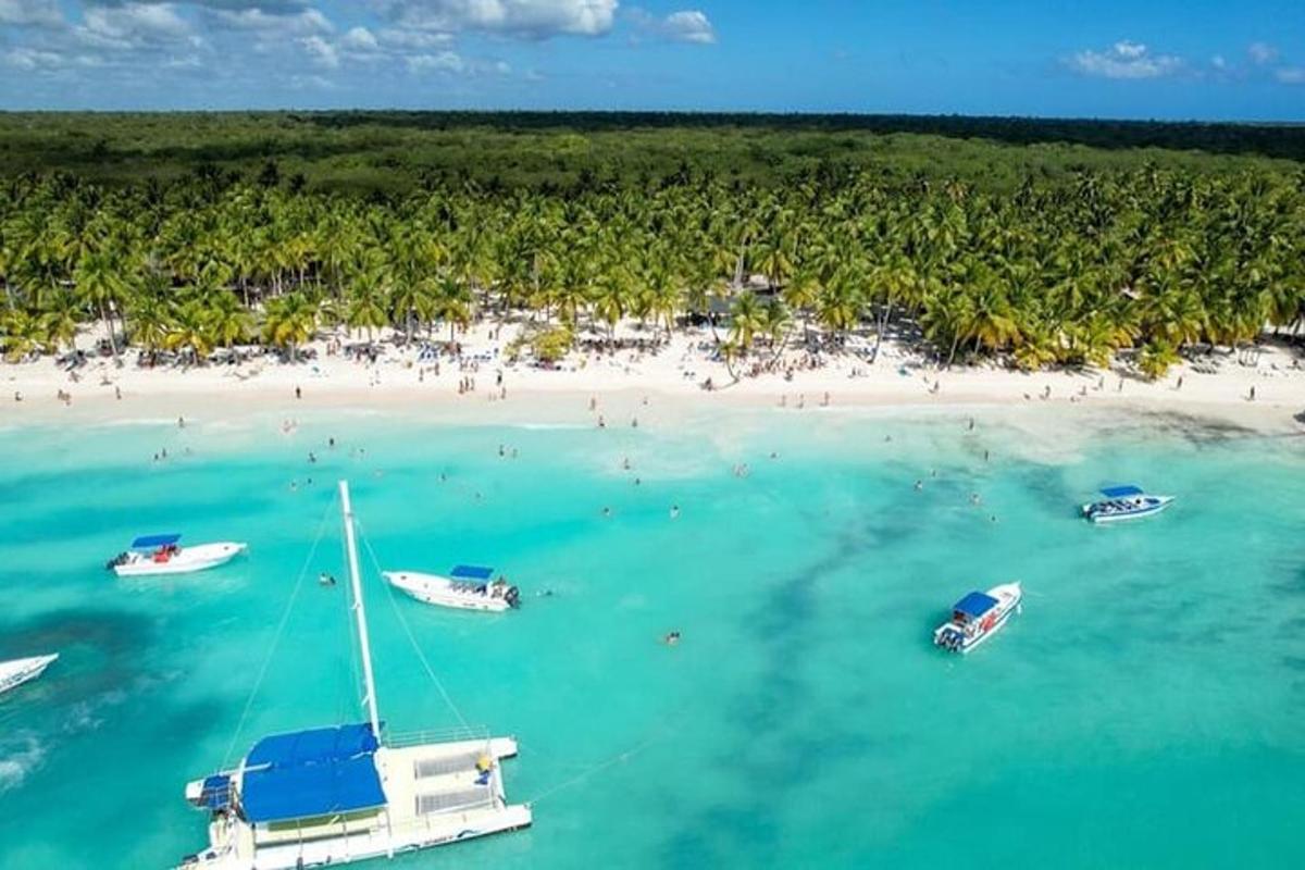an aerial view of a beach with boats in the water