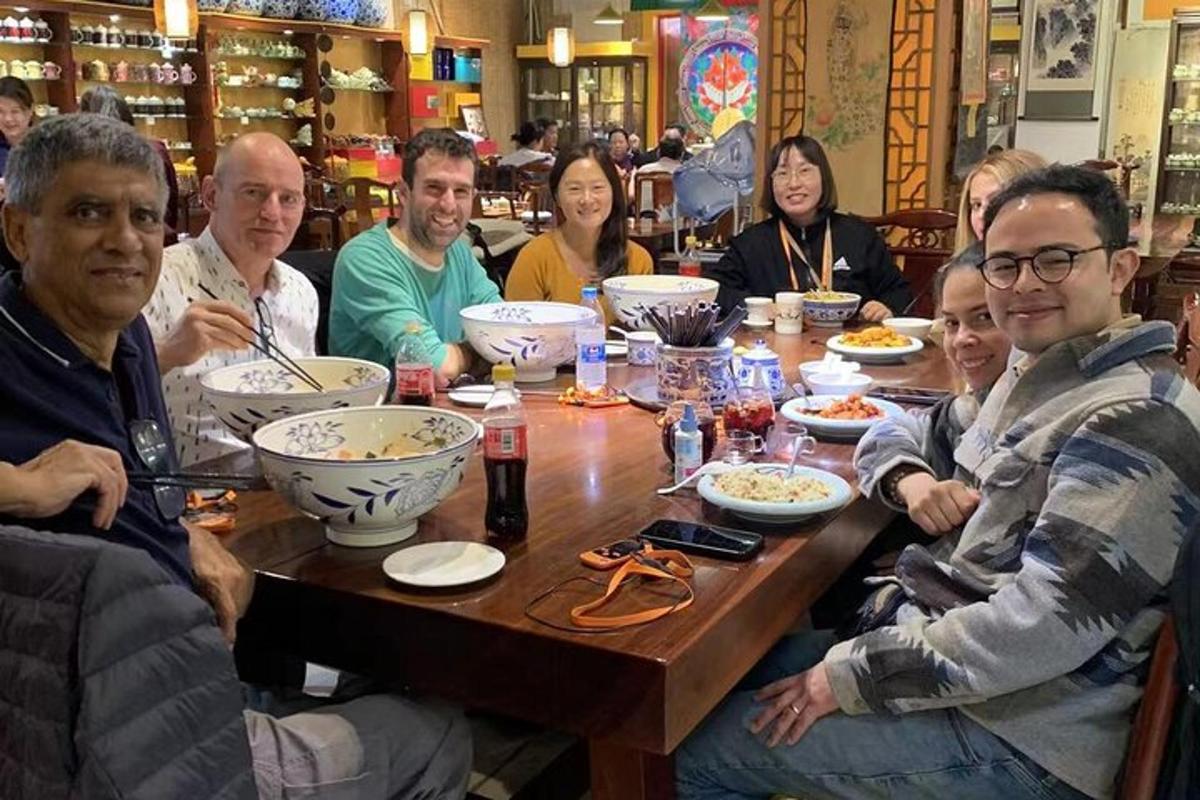 a group of people sitting around a wooden table