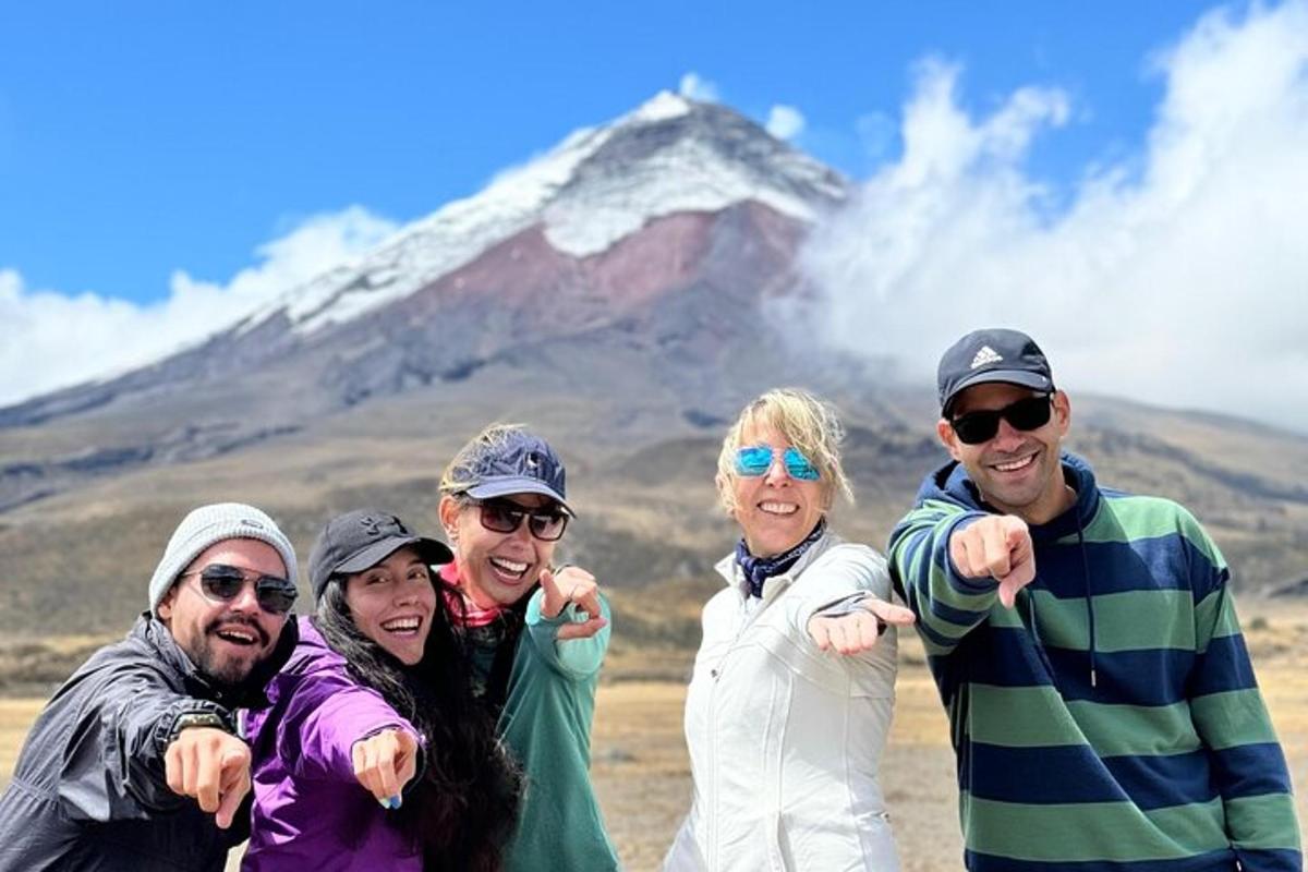 a group of people standing in front of a mountain