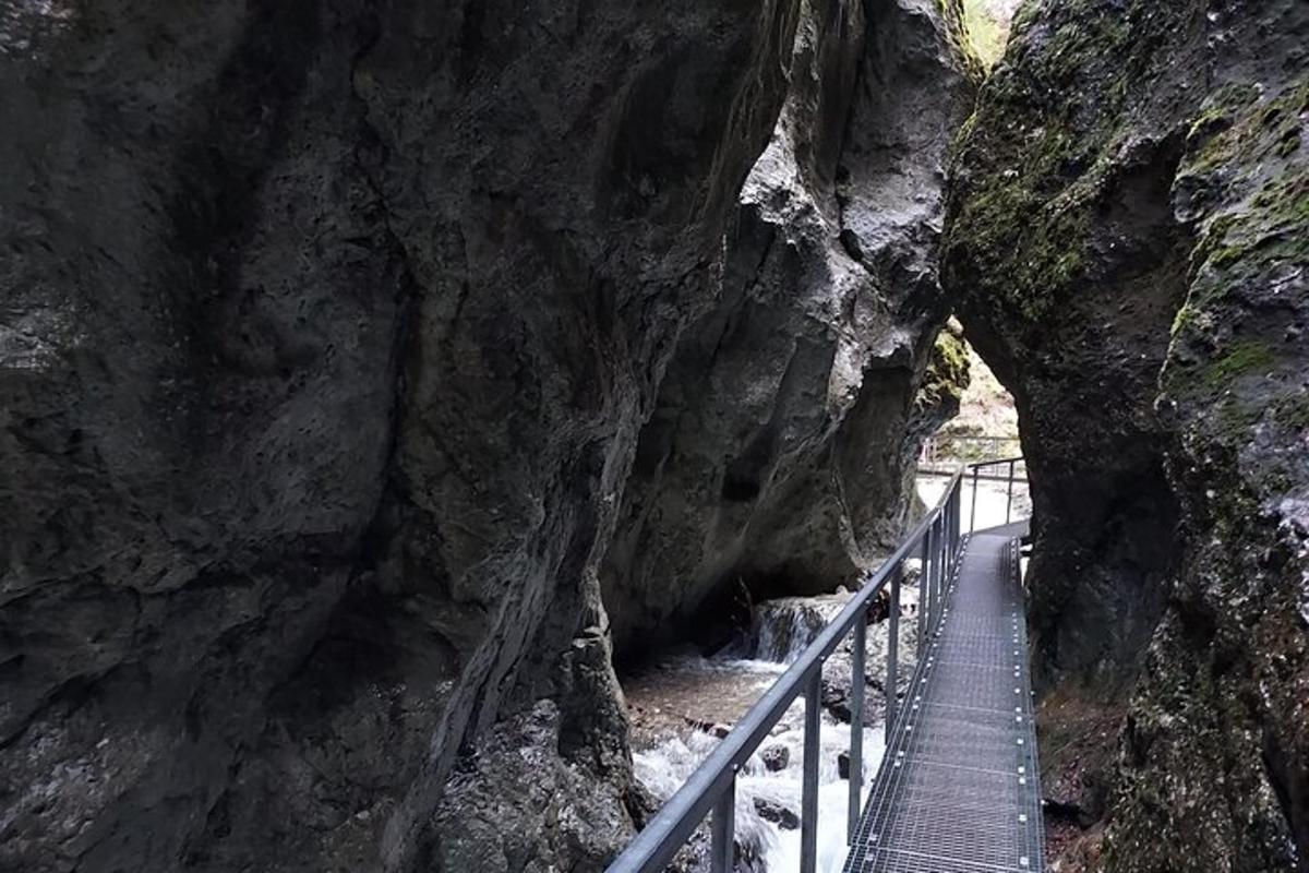 a walkway in a rocky mountain with a bridge