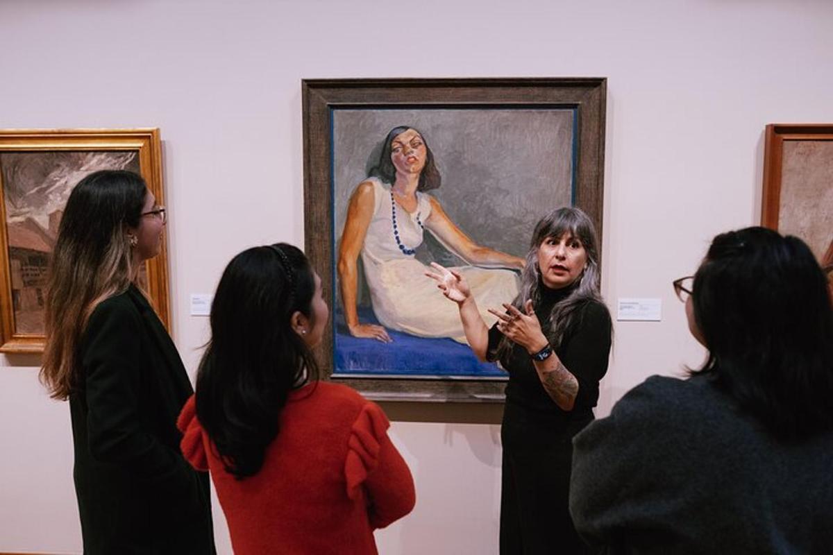 a group of women standing in front of a painting