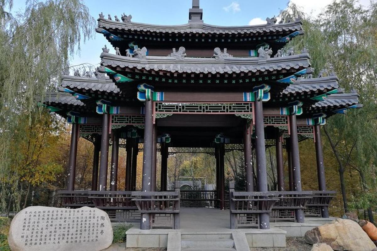 a large building with benches in a park